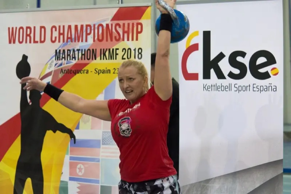 Anna performing a one-arm kettlebell snatch at the World Championship Marathon IKMF 2018