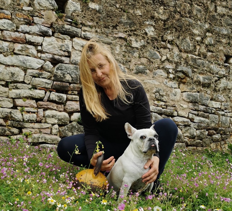 Anna with her beloved dog Nacho in a wildflower field